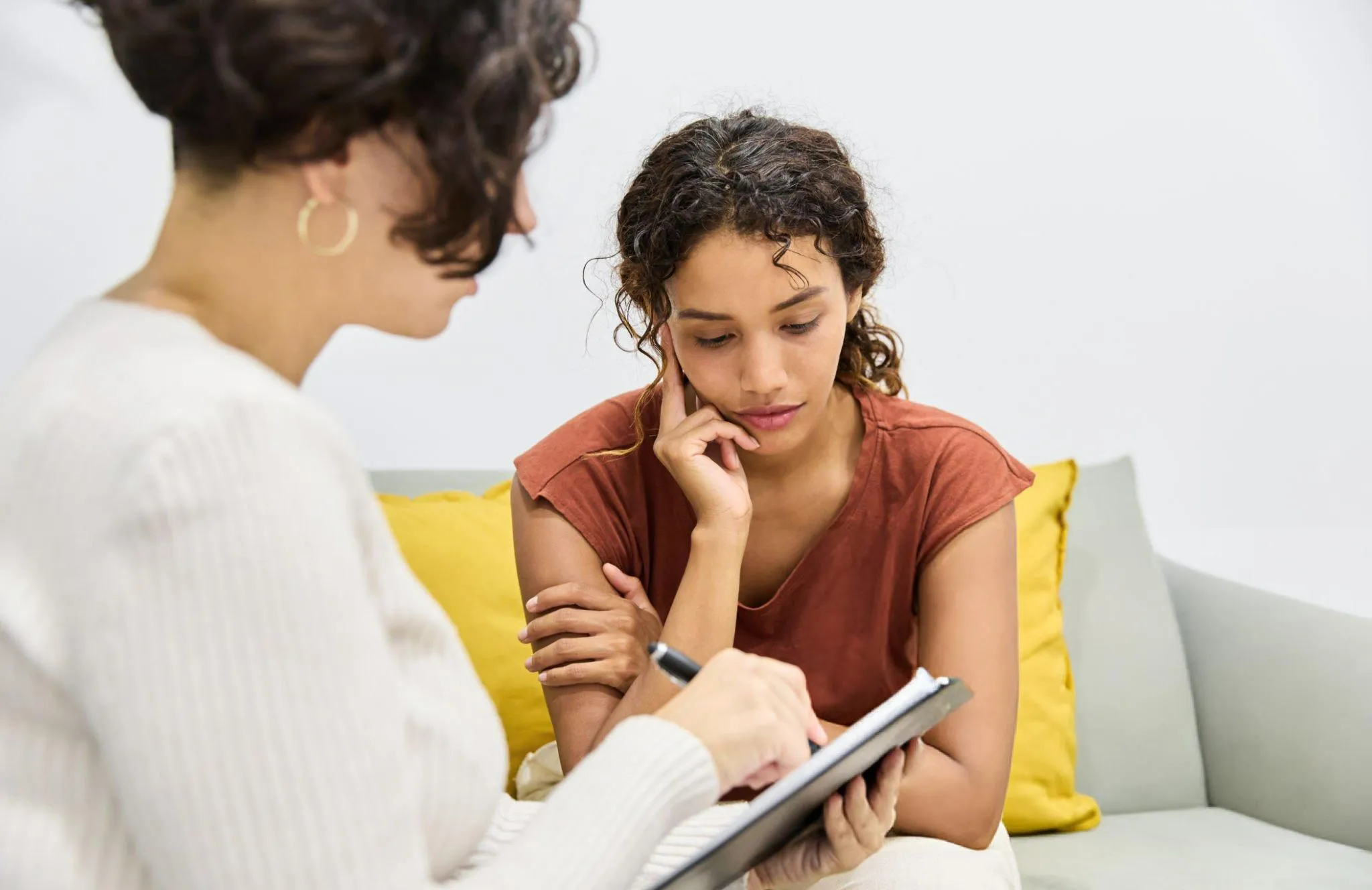 A depressed girl is talking to a therapist
